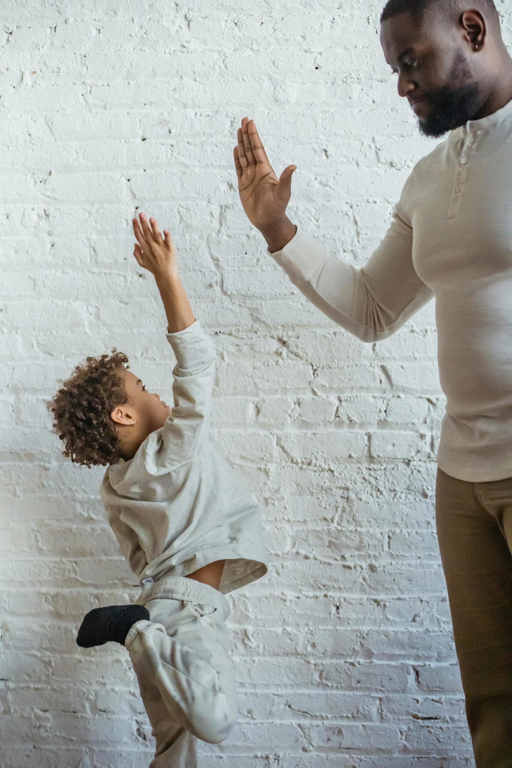 Dad giving son high five