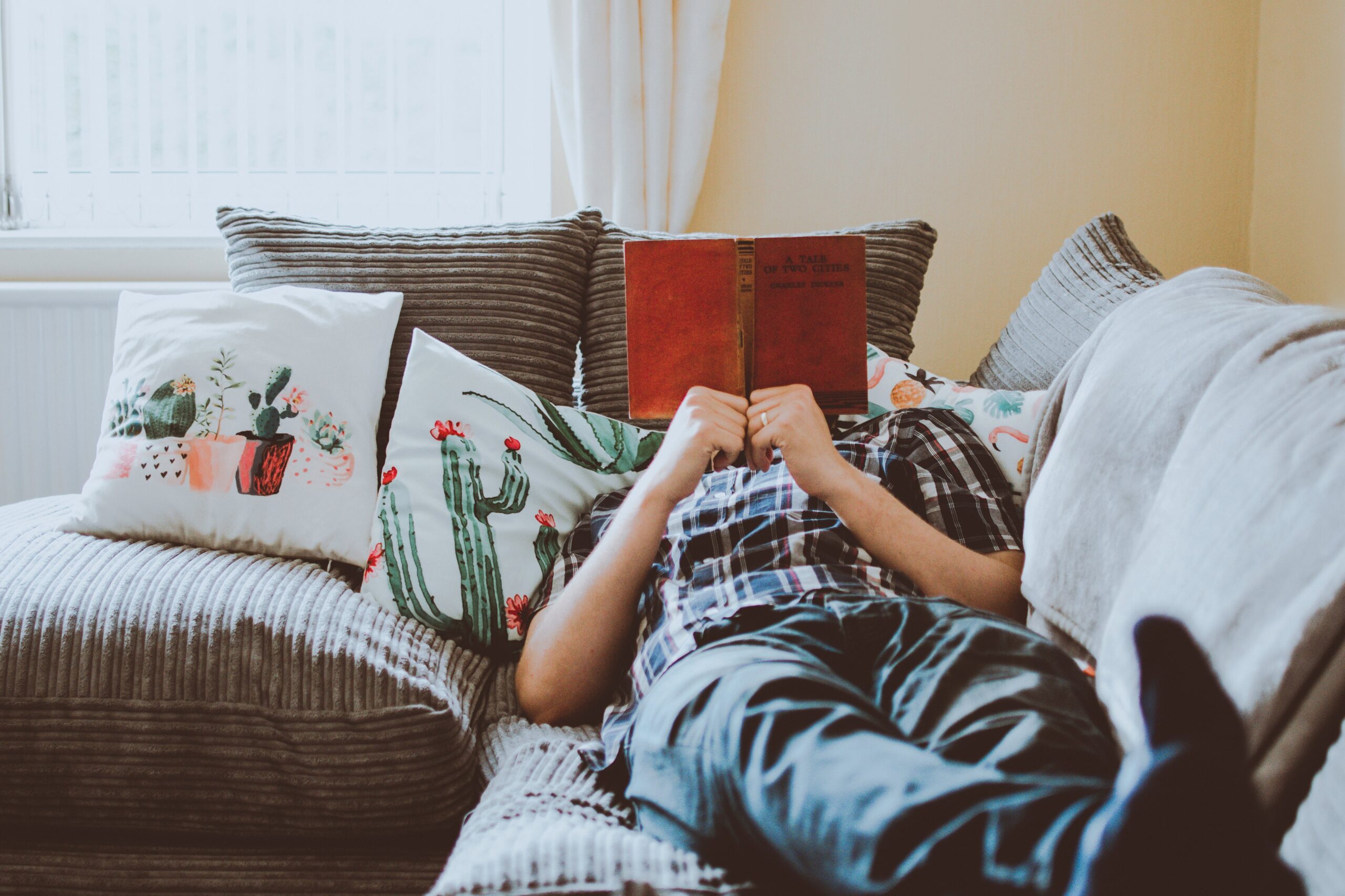 man reading on couch