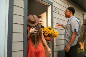 Couple visiting friend bringing flowers