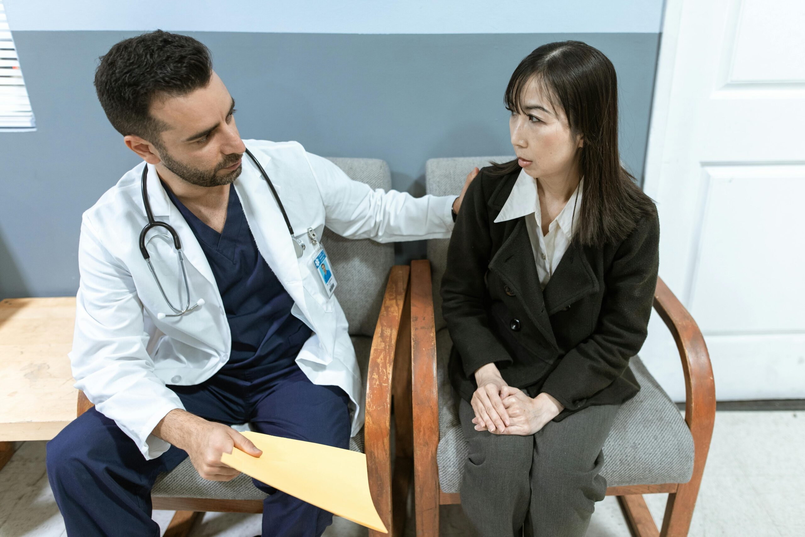 Doctor comforting asian woman