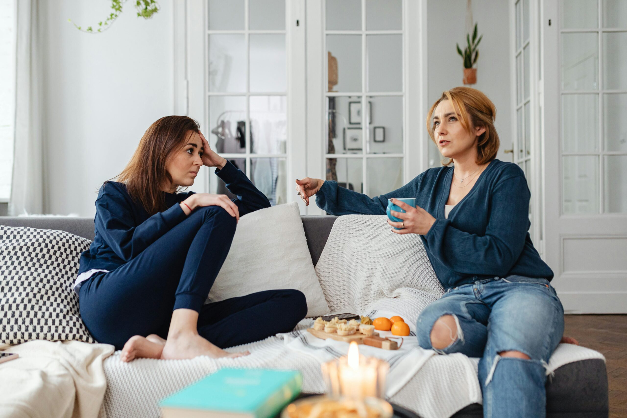 women talking on couch